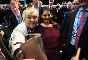 A conference attendee taking a selfie with Priti Patel, the home secretary.