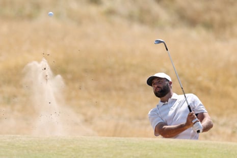 Scottie Scheffler plays a shot from a bunker on the fourth