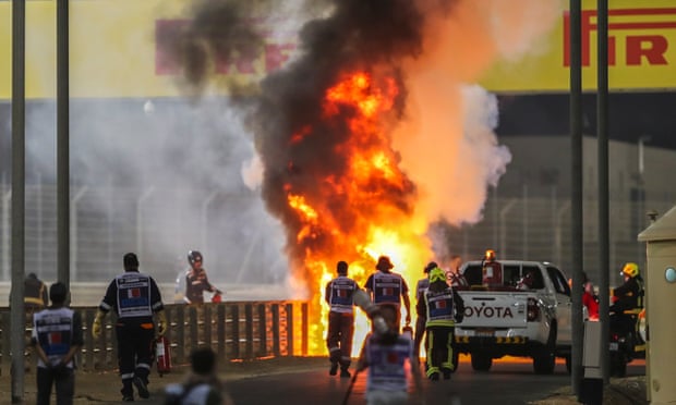 Romain Grosjean escapes to safety after his Haas split in two and burst into flames.