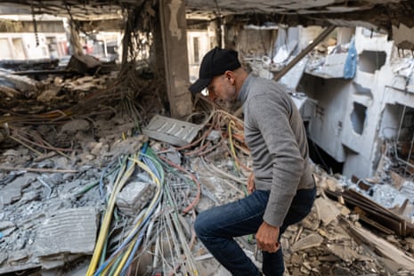 Workers and engineers clear up and assess the aftermath of an Israeli attack on a residential block in the Bashoura neighbourhood of central Beirut