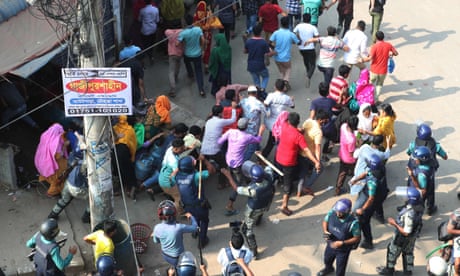 Bangladeshi security personnel charge to disperse garment workers protesting in Gazipur on 9 November 2023, after the Minimum Wage Board authority declared the minimum wage of 12,500 taka (£92) for garment workers.