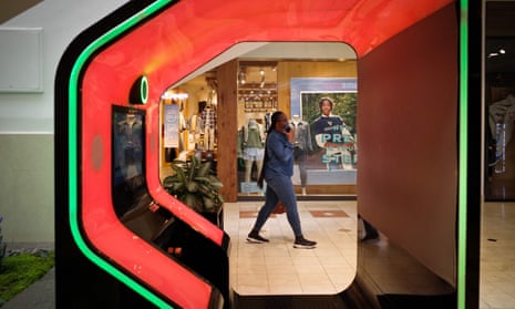 A shopper walks past a lit booth inside a shopping mall in Bethesda, Maryland.