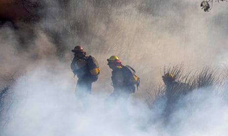 Fire fighters work to contain the Eaton fire in Altadena, California