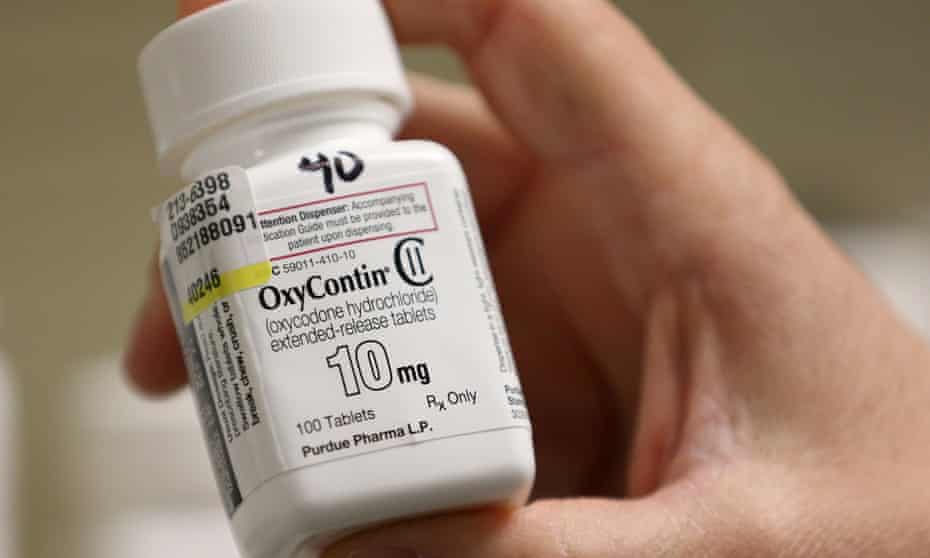 A pharmacist holds a bottle OxyContin made by Purdue Pharma.