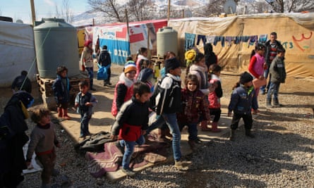 Syrian refugee children leave a makeshift school in a displacement camp in Lebanon.