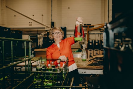Cressida Granger holds up an uncapped lava lamp in a production room