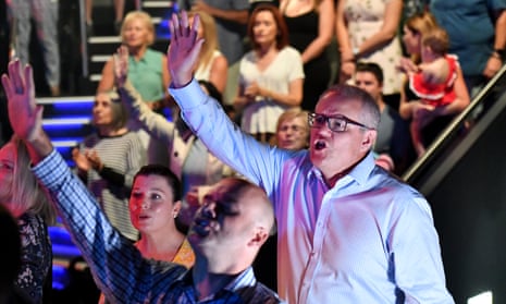 Prime Minister Scott Morrison and wife Jenny sing during an Easter Sunday service at his Horizon Church at Sutherland in Sydney, Sunday