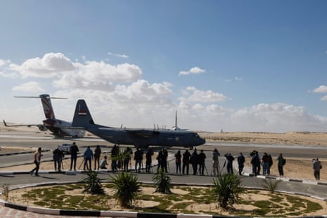 Reporters gather near airplanes bringing aid for the Gaza Strip on the tarmac of Egypt's El-Arish airport.