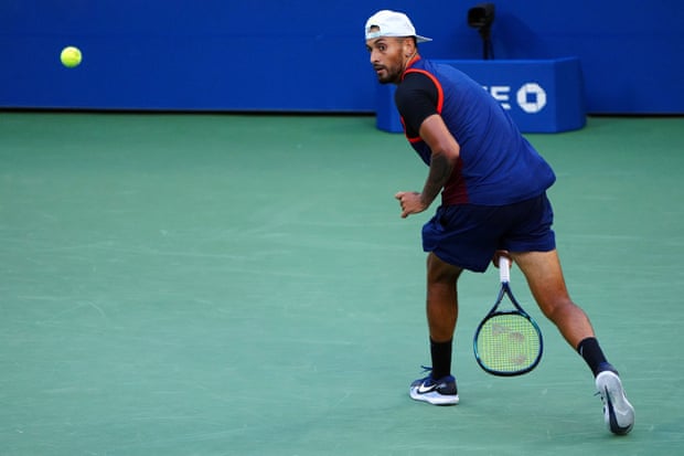 Kyrgios plays a shot between his legs.