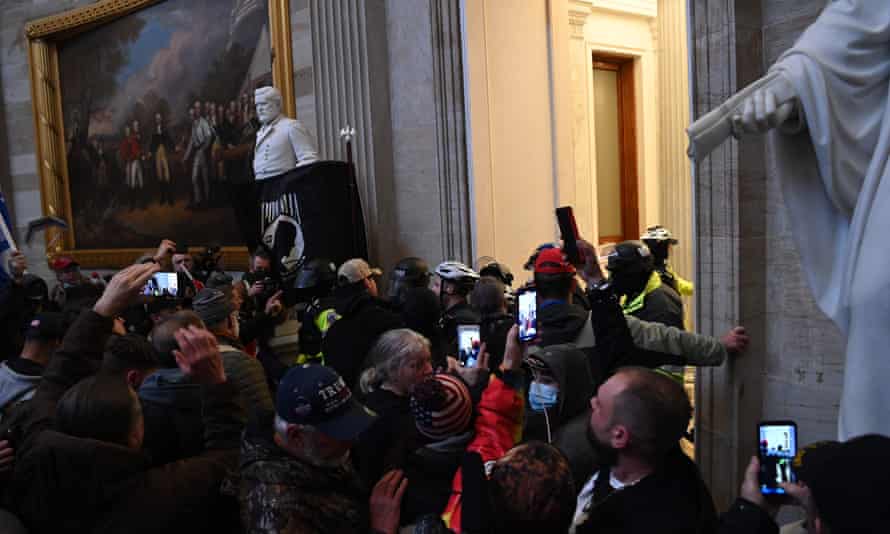 A mob storms the US Capitol’s Rotunda as Congress debates the a 2020 presidential election electoral vote certification.