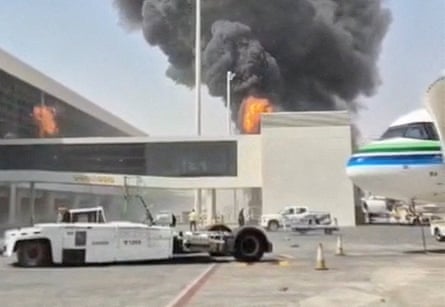 Thick black smoke and flames rise above Riyadh airport’s terminal near a parked aircraft
