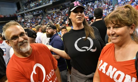 People wearing QAnon T-shirts await Donald Trump’s arrival at a political rally in Wilkes-Barre, Pennsylvania, last week.
