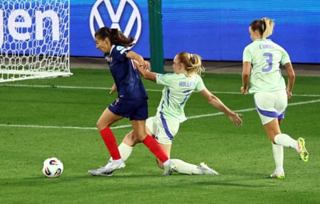 Wales’ Ceri Holland fouls France’s Clara Mateo to concede a penalty.