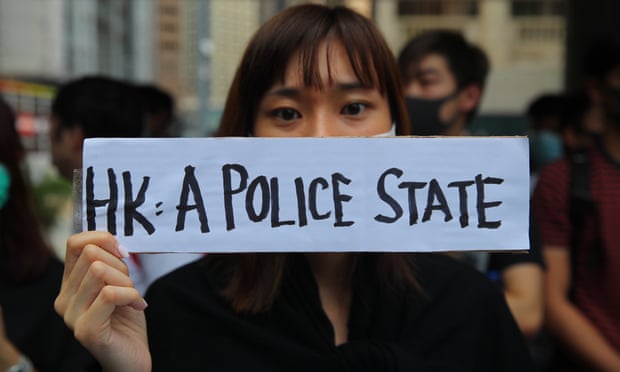 A woman holds a sign during a demonstration held to protest alleged abuse of pro-democracy protesters by Hong Kong police.