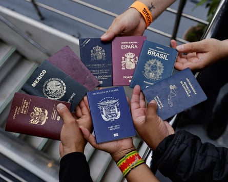 Activists show passports from their respective countries during the Yaku Mama flotilla