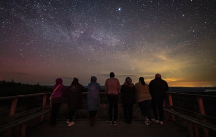 People staring at a night sky with multitude