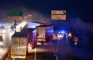 Refugees block a truck on the highway near the make-shift camp on Monday night.