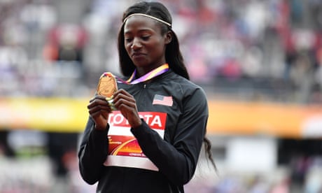 Tori Bowie examines her gold medal 