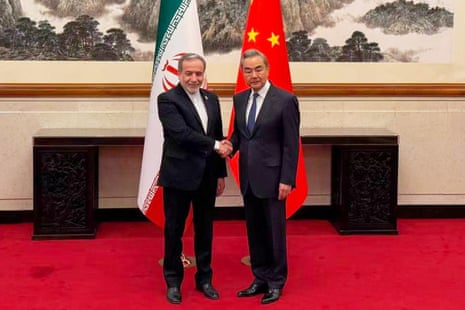 The Iranian foreign minister, Abbas Araghchi, shakes hands with China’s foreign minister, Wang Yi.