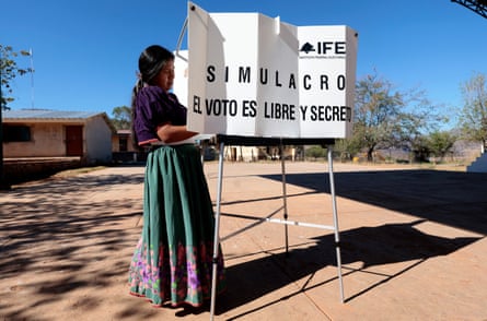 A Wixarika Indigenous woman casts her vote at an elementary school during a mock election day drill in Tuxpan de Bolaños, Jalisco, this month.