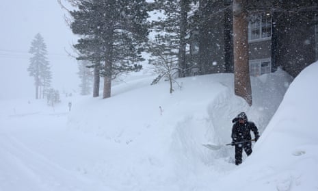 A man shovels snow in the Sierra Nevada mountains on Tuesday in Mammoth Lakes, California.