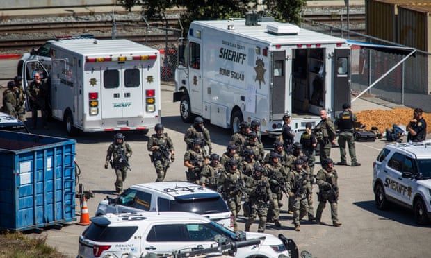 Tactical law enforcement officers move through the light-rail yard in San Jose, California, on Wednesday where a mass shooting left 10 people dead, including the gunman.