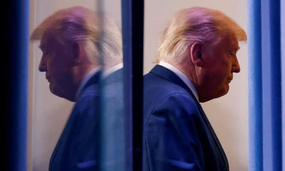 Donald Trump is reflected as he departs after speaking at the White House in Washington DC Thursday.