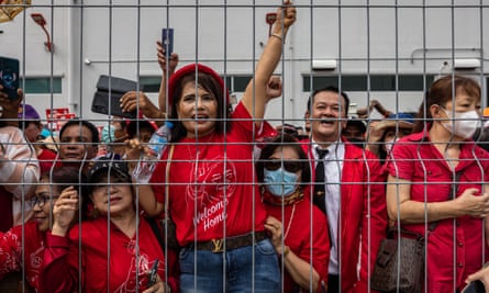 Supporters of Thaksin Shinawatra wait for his arrival at Don Mueang international airport in Bangkok