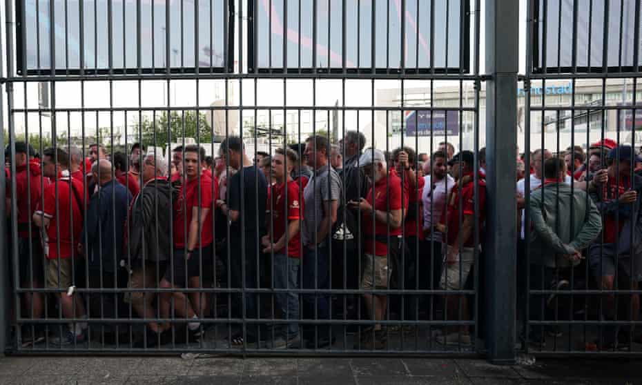 Liverpool fans wait outside a turnstile at the Stade de France. Supporters we spoke to have described dangerous overcrowding and confusing security measures.