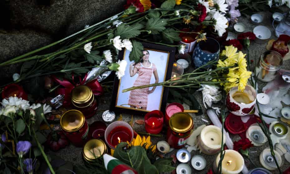 Flowers and candles are placed near a portrait of slain Bulgarian television journalist Viktoria Marinova in the city of Rousse.