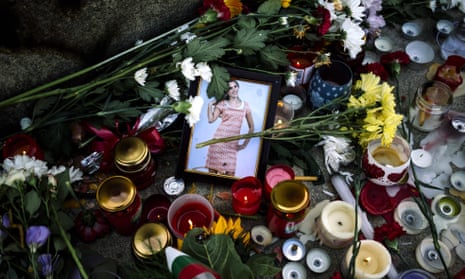 Flowers and candles are placed near a portrait of slain Bulgarian television journalist Viktoria Marinova in the city of Rousse.