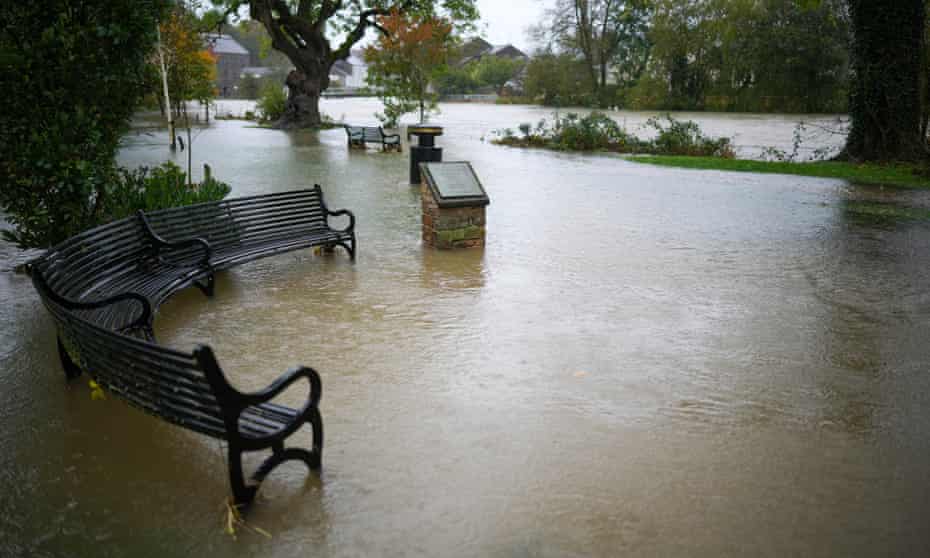 Park benches are maroooned as the River Derwent breaks its banks after torrential overnight rain on Friday in Cockermouth.