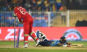 Pathum Nissanka of Sri Lanka is run out as Jos Buttler of England removes the bails.
