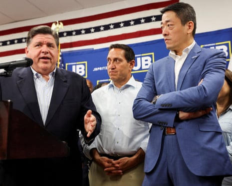 Illinois’s governor, JB Pritzker, speaks alongside the Texas state representatives Trey Martinez and Gene Wu in Carol Stream, Illinois, on Sunday.