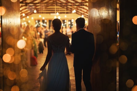 A young couple arriving hand in hand at their wedding reception