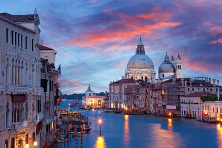 Canal and ornate old builings in Venice at dusk