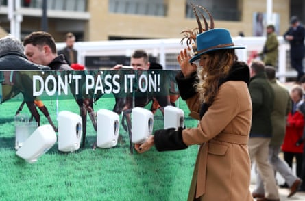 Race-goers use hand sanitiser installed at Cheltenham Racecourse to help curb the spread of the Corona Virus at Cheltenham Racecourse on March 10, 2020 in Cheltenham, England.