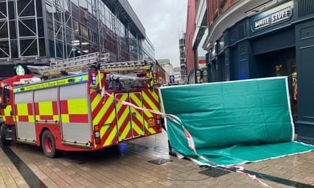 Emergency services at the scene where scaffolding was dislodged in Belfast city centre during Storm Isha, injuring one person.