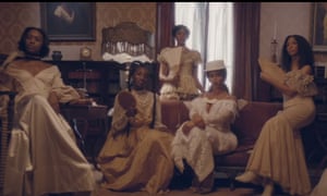 Beyoncé and a group of women in white, antebellum-inspired fashion in the video for her new single Formation.