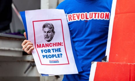 An activist holds a flyer questioning Senator Joe Manchin on Capitol Hill on Tuesday.