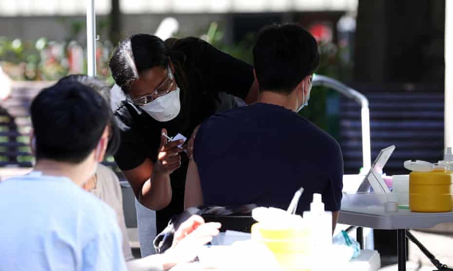 A man receives a vaccination at a Cohealth pop-up vaccination clinic at the State Library Victoria