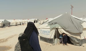 a woman and children in Syria's al-Hawl refugee camp