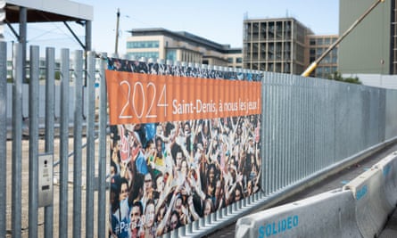 A sign on a fence by the Olympic village