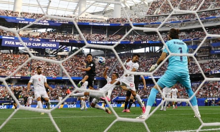 New Zealand’s Elijah Just thumps the ball past Iran’s keeper