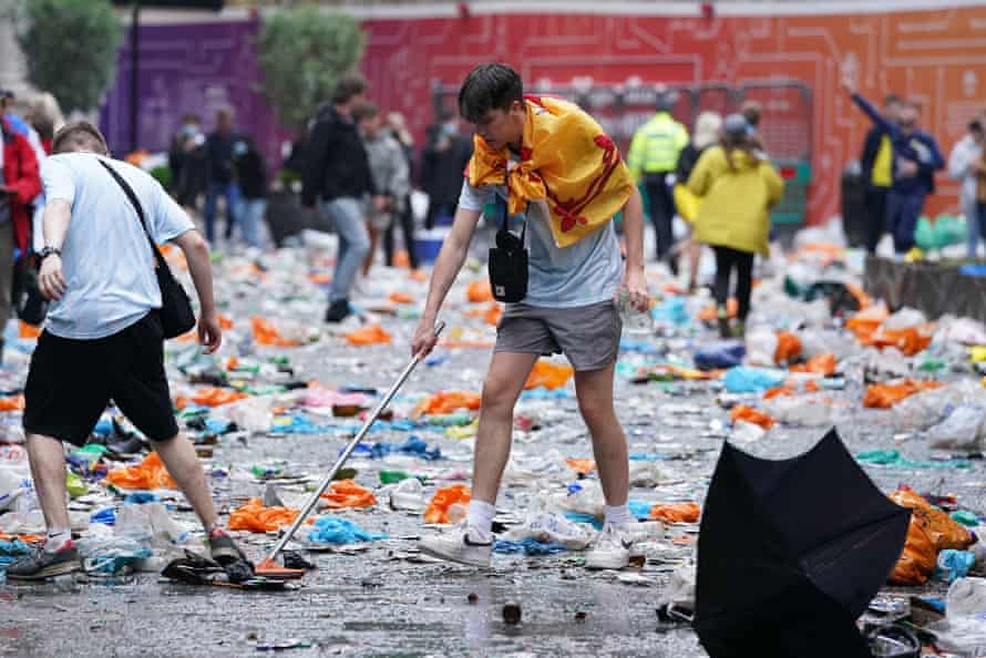 Scotland fans clean up litter in Leicester Square, London, before the Euro 2020 match between England and Scotland.