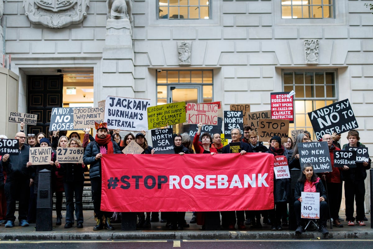 Climate protesters from Fossil Free London hold placards during a protest against the Jackdaw decision outside the Department for Energy Security and Net Zero in London this morning.