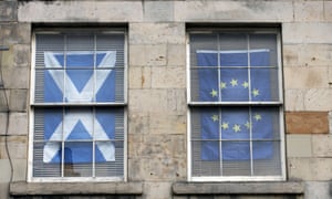 The Scottish Saltire and the EU flag hanging in windows of a flat in Edinburgh.