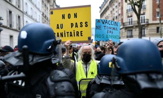 Protesters in Paris yesterday hold signs reading ‘No to the health pass’ and ‘Vaccine: keep away from our children’