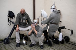 Three men wearing chainmail-style knit tops preparing for Karandash-Fest, a street festival of circus performers.