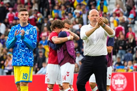 Denmark’s national coach Brian Riemer, right, and players acknowledge the crowd after the game was abandoned.